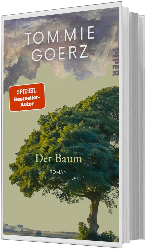 Das Buchcover zeigt einen großen, einzeln stehenden Baum mit dichtem grünen Laub vor einem hellolivgrünen Hintergrund und dramatischen Wolken in Grau- und Violetttönen am oberen Rand. Oben steht der Autorenname in weißen Großbuchstaben „TOMMIE GOERZ“, mittig der Titel „Der Baum“ in serifenbetonter, hellgelber Schrift und darunter „Roman“. Links ein roter rechteckiger Hinweisbutton mit weißer Aufschrift „SPIEGEL Bestseller-Autor“. Stimmung ruhig, leicht melancholisch.