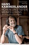 Das Buchcover zeigt ein Porträt von Hans Kammerlander. Er sitzt relaxed an einem Holztisch und blickt nachdenklich, während er die Hände ornamentiert in seiner Nähe hält. Der Hintergrund ist unscharf und besteht aus warmen Holztönen, die eine einladende Atmosphäre schaffen. Der Titel „HÖHEN UND TIEFEN MEINES LEBENS“ steht in großen, weißen Buchstaben oben, darunter sind die Namen der Autorinnen Verena Duregger und Mario Vigl in kleinerer Schrift zu sehen. Die Schrift ist modern und klar, das gesamte Cover strahlt eine ruhige, authentische Stimmung aus.