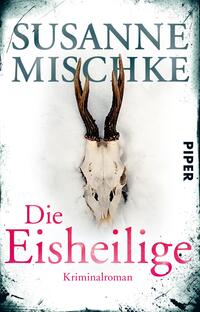 Das Buchcover zeigt einen weißen Hintergrund, der mit einem leicht gräulichen Verlauf versehen ist. In der Mitte befindet sich ein Tierkopf mit markanten, gewundenen Hörnern. Der Titel „Die Eisheilige“ ist in einer großen, pinkfarbenen Schriftart platziert, während der Autorenname „Susanne Mischke“ in eleganter, grauer Schrift oberhalb steht. Am unteren Rand ist das Wort „Kriminalroman“ in kleinerer Schrift zu sehen. Die Gesamtatmosphäre wirkt mysteriös und aufregend.