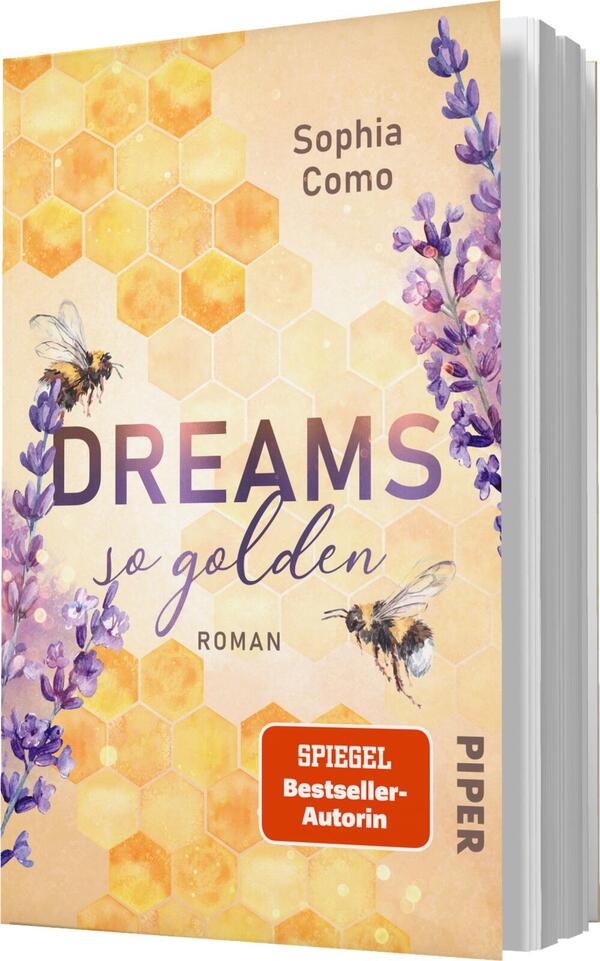 Das Buchcover zeigt eine sanfte, pastellfarbene Hintergrundgestaltung mit einem Honigwabenmuster. In der Mitte des Covers steht der Titel „DREAMS so golden“ in eleganter, geschwungener Schrift, während der Untertitel „Roman“ in schlichterer Typografie darunter platziert ist. Oben befindet sich der Name der Autorin, Sophia Como. Am linken Rand sind zarte Lavendelpflanzen und Bienen abgebildet, die eine harmonische und verträumte Atmosphäre vermitteln. Ein orangefarbener Sticker mit dem Text „SPIEGEL Bestseller-Autorin“ ist ebenfalls sichtbar.