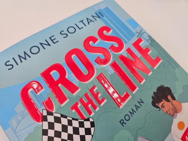 Außenansicht des Buches „Cross the Line – Auf der Rennstrecke kämpft er um den Sieg, im Leben um ihr Herz“