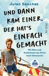 Das Buchcover zeigt einen fröhlichen jungen Mann mit blonden Haaren, der lächelt und sich auf einem Boot befindet, umgeben von Wasser und blauen Himmel. Der Titel „UND DANN KAM EINER, DER HAT'S EINFACH GEMACHT“ ist in großen, auffälligen, schwarzen Buchstaben platziert. Darunter steht der Untertitel „Mit Bike und Ruderboot von Paris nach Vancouver“ in kleinerer Schrift. Die Farben sind hell und einladend, was eine abenteuerliche und freudige Atmosphäre vermittelt. Der Autor Julen Sánchez ist ebenfalls namentlich erwähnt.