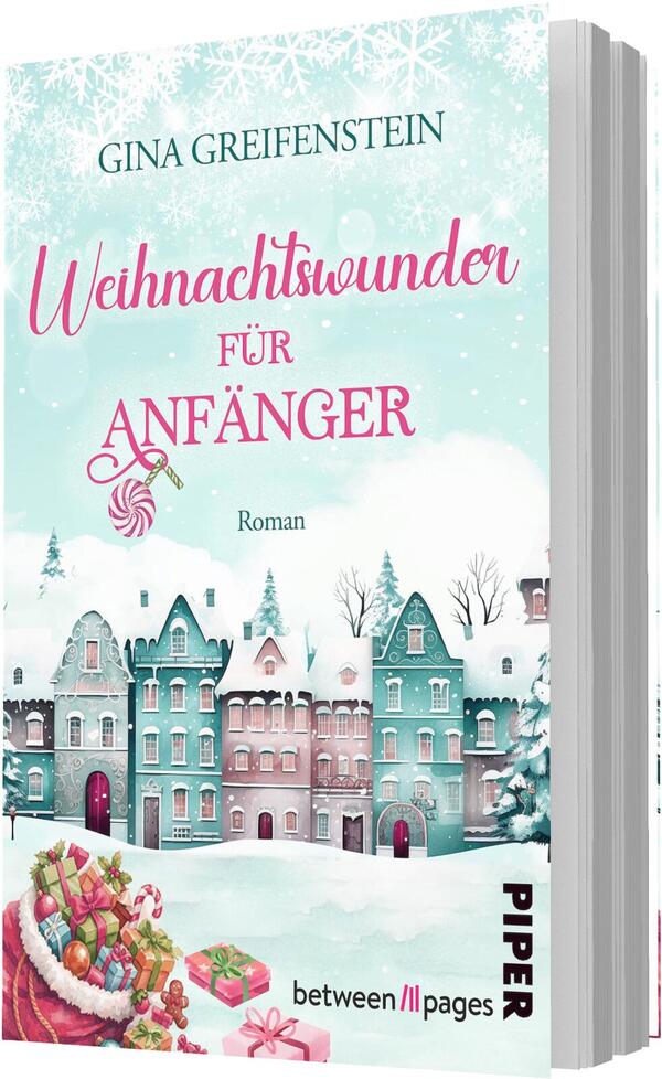 Das Buchcover zeigt eine winterliche, heimelige Straßenansicht mit schneebedeckten, pastellfarbenen Stadthäusern in Mint, Türkis und Rosa vor hellblauem, mit Schneeflocken bestreutem Himmel. Oben steht der Autorenname Gina Greifenstein, der Titel „Weihnachtswunder für Anfänger“ ist in pinker, verspielter Handschrift für „Weihnachtswunder“ und serifenbetonter Versaltypografie für „ANFÄNGER“, ergänzt durch eine Bonbonornament-Illustration. Unten links liegt ein Korb mit bunten Geschenken.