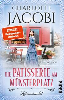 Das Buchcover zeigt eine historische Szene mit einer weiblichen Figur in einem eleganten, blauen Kleid, die vor einem charmanten, roten Patisserie-Geschäft steht. Die Atmosphäre strahlt Nostalgie und Gastronomie aus. Der Titel „Die Patisserie am Münsterplatz“ ist in geschwungener Schrift in der unteren Mitte platziert, während der Autorennamen „Charlotte Jacobi“ oben hervorgehoben wird. Ein orangefarbener Hinweis „SPIEGEL Bestseller-Autorin“ zieht die Aufmerksamkeit auf sich. Der Hintergrund ist hell und freundlich gestaltet.