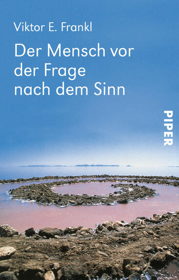 Das Buchcover zeigt eine weite, friedliche Landschaft mit einem sanften, blauen Himmel und einer ruhigen Wasserfläche. In der Mitte sind kreisförmige Steinanordnungen zu sehen, die sich harmonisch in die Umgebung einfügen. Der Titel „Der Mensch vor der Frage nach dem Sinn“ ist in klarer, weißer Schrift am oberen Rand platziert, während der Autor „Viktor E. Frankl“ darüber steht. Unten rechts ist das Verlagslogo „PIPER“ in vertikaler Ausrichtung. Die Farben vermitteln eine ruhige und nachdenkliche Atmosphäre.