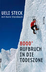 Das Buchcover zeigt einen Bergsteiger in einem roten Anorak, der eine steile, vereiste Wand mit Eispickeln erklimmt. Der Hintergrund ist von einem klaren blauen Himmel und massiven, weißen Schneemassen geprägt, was die Kälte und Schwierigkeit der Umgebung betont. In der oberen linken Ecke steht in schwarzer Schrift „Ueli Steck“ und darunter, in kleinerer Schrift, „mit Karin Steinbach“. In der unteren Mitte ist der Titel „8000+ AUFBRUCH IN DIE TODESZONE“ in auffälliger roter und schwarzer Typografie gestaltet. Rechts ist das Verlagslogo „MALIK“ zu sehen.