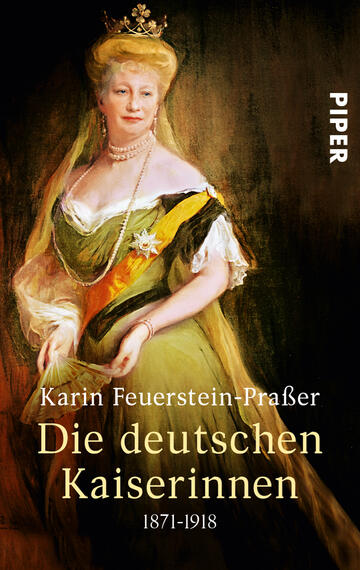 Das Buchcover zeigt eine elegante Frau in historischer Kleidung mit einer hellgrünen Robe und einem prunkvollen Diadem. Die Frau ist leicht seitlich dargestellt, mit einem sanften Lächeln auf dem Gesicht. Ihre Augen strahlen, und sie trägt eine Vielzahl von Schmuckstücken. Der Titel „Die deutschen Kaiserinnen“ erscheint in goldener Schrift, während der Autorenname „Karin Feuerstein-Prässer“ in einer etwas kleineren, weißen Schrift darunter steht. Der Hintergrund ist in warmen, sanften Farbtönen gehalten, die eine nostalgische Atmosphäre verleihen.