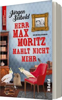 Das Buchcover zeigt einen hellblauen Hintergrund mit einem stilisierten Tapetenmuster. Im Vordergrund sind eine rote Sessel und zwei weiße Vögel abgebildet. Oben befindet sich ein goldener Bilderrahmen mit einer Zeichnung von zwei Personen. Der Titel „Herr Max Moritz mahlt nicht mehr“ ist in großen, roten Buchstaben hervorgehoben, während „Kriminalroman“ in kleinerer, schwarzer Schrift darunter steht. Der Autor „Jürgen Seibold“ ist oben links platziert in einer eleganten Schriftart.