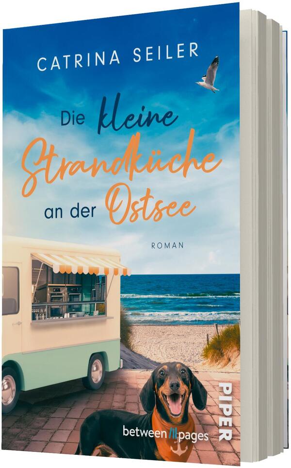 Das Buchcover zeigt eine sonnige Meeresküste mit blauem Himmel, Möwe im Flug und Wellen an einem Sandstrand; links ein pastellgrüner Imbisswagen mit offenem Fenster und Markise, vorne auf dem Weg ein fröhlicher Dackel. Titel in großer Typografie: oben „CATRINA SEILER“, mittig „Die kleine Strandküche an der Ostsee“ in einer Kombination aus serifenloser und handschriftlicher, orangefarbener Schrift; unten kleingedruckt „ROMAN“.