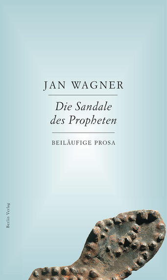 Das Buchcover zeigt einen sanften, hellblauen Hintergrund. In der oberen Hälfte steht in klarer, schwarzer Schrift der Name „Jan Wagner“. Darunter befindet sich der Titel „Die Sandale des Propheten“ in einer etwas größeren Schriftart. Am unteren Rand des Covers ist der Zusatz „BEILÄUFIGE PROSA“ ebenfalls in schwarzer Schrift zu lesen. Im Vordergrund ist eine großformatige Abbildung einer alten Sandale mit sichtbaren Nägeln, die den Bezug zum Titel herstellt.