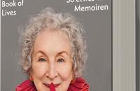 Das Buchcover zeigt ein Portrait von Margaret Atwood, die lächelnd in die Kamera blickt. Sie trägt ein helles Oberteil und auffällige, rote Handschuhe. Der Hintergrund ist schlicht und hell gehalten. Oben auf dem Cover steht in Großbuchstaben „MARGARET ATWOOD“, darunter der Titel „Book of Lives“ in kleinerer, eleganter Schrift. Am unteren Rand ist der Untertitel „So etwas wie Memoiren“ zu sehen. Ein Hinweis auf „SPIEGEL Bestseller-Autorin“ befindet sich ebenfalls auf dem Cover.