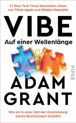 Das Buchcover zeigt großen schwarzen Titel „VIBE“ in serifenloser Großschrift, darunter der Untertitel „Auf einer Wellenlänge“ und der Autorenname ADAM GRANT in schwarzer Großschrift. In der Mitte zwei ineinandergreifende Puzzle-Teile, links irisierendes Blau‑Lila, rechts Orange‑Rot, verbunden durch einen goldenen Reißverschluss. Weißer Hintergrund, oben orangefarbene Hinweiszeile zum Bestsellerstatus, insgesamt modern, kontrastreich und optimistisch wirkend.