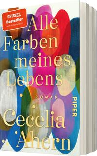 Das Buchcover zeigt eine bunte Auswahl von ovalen Farbformen in lebhaften Tönen wie Rot, Blau, Grün und Gelb auf einem sanften weißen Hintergrund. Der Titel „Alle Farben meines Lebens“ ist in eleganter, goldener Schrift mit großem, prägnantem Schriftzug gestaltet. Darunter steht in kleinerer Schrift das Wort „Roman“. Der Autorennamen „Cecelia Ahern“ ist ebenfalls in goldener Schrift am unteren Rand des Covers platziert. Oben links befindet sich ein rotes Aufkleberlabel mit dem Text „SPIEGEL Bestseller“.