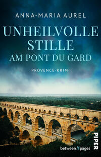 Das Buchcover zeigt eine dramatische Ansicht des römischen Aquädukts Pont du Gard in warmem Ockerton vor einem dunklen, sturmblauen Himmel mit Nebelschleier. Titel „Unheilvolle Stille am Pont du Gard“ erscheint groß, hellblau, in versaler Serifenschrift; darunter klein die Genrebezeichnung „Provence‑Krimi“. Oben steht die Autorin Anna‑Maria Aurel in weißer, schlichter Schrift. Die Stimmung ist bedrohlich und melancholisch.