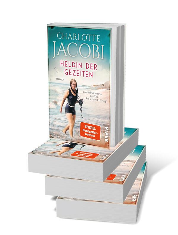 Bücherstapel des Buches „Heldin der Gezeiten – Eine Schwimmerin. Ein Ziel. Ein weltweiter Erfolg.“