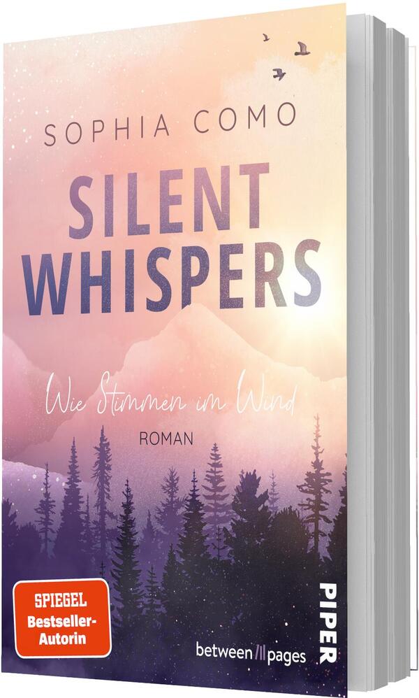 Das Buchcover zeigt einen sanft verlaufenden Himmel in Pastelltönen (Pfirsich, Rosa, Hellgelb) über violetten Berg- und Nadelwald-Silhouetten; drei Vögel fliegen rechts oben. Oben steht der Autorenname „Sophia Como“, der Titel „Silent Whispers“ in großer, fetter, violett verlaufender Grotesk, darunter in handschriftlicher Kursivschrift der Untertitel „Wie Stimmen im Wind“ und die Genreangabe „Roman“. Stimmung ruhig, melancholisch, verträumt.
