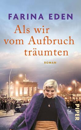Das Buchcover zeigt eine Frau mit blonden Haaren, die lächelnd im Vordergrund steht und einen lila Umhang trägt. Der Hintergrund zeigt eine historische Szenerie, möglicherweise eine Menschenmenge vor einem großen Gebäude, das eine symbolische Bedeutung hat. Der Himmel ist in sanften Farbnuancen von Blau und Lila gehalten. Der Titel „Als wir vom Aufbruch träumten“ ist in orangefarbenen, auffälligen Lettern geschrieben, während der Autorennamen „Farina Eden“ in lila darüber steht. Am unteren Rand ist das Verlagslogo „PIPER“ zu sehen.