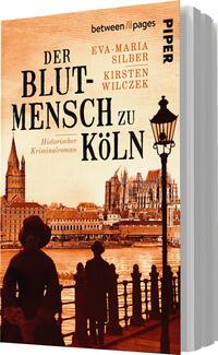 Das Buchcover zeigt eine illustrierte Stadtansicht von Köln in warmen, orangen und braunen Tönen. Im Vordergrund sind zwei stilisierte Figuren zu sehen, die vor einer historischen Kulisse stehen. Die Typografie ist groß und markant, mit dem Titel „DER BLUTMENSCH zu KÖLN“ in fetter Schrift. Darunter steht in kleinerer Schrift „Historischer Kriminalroman“. Die Autorinnen Eva-Maria Silber und Kirsten Wilczek sind ebenfalls erwähnt. Die Gesamtatmosphäre vermittelt Spannung und historische Tiefe.