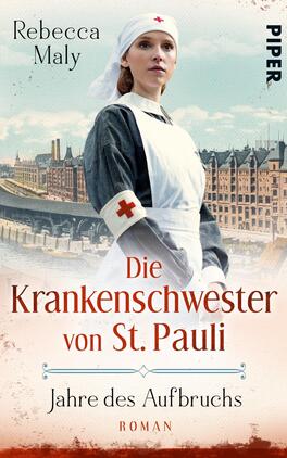 Die Krankenschwester von St. Pauli – Jahre des Aufbruchs Das Buchcover zeigt eine Krankenschwester in historischer Uniform mit rotem Kreuz auf ihrem Arm, die vor einer Stadtkulisse steht, die an Hamburg erinnert. Die Farben sind überwiegend in sanften Blau- und Cremetönen gehalten, was eine nostalgische Atmosphäre vermittelt. Über dem Bild steht der Titel „Die Krankenschwester von St. Pauli“ in geschwungener, roter Schrift. Darunter befindet sich der Untertitel „Jahre des Aufbruchs“ und das Wort „Roman“ in kleinerer Schrift. Der Name der Autorin, Rebecca Maly, ist oben links platziert.