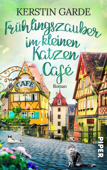 Das Buchcover zeigt eine malerische Straßenszene mit bunten Fachwerkhäusern und einem einladenden Café. In warmen Pastellfarben gestaltet, dominiert ein sanfter Grünton, der eine fröhliche Frühlingsatmosphäre vermittelt. Die Titelzeilen „Frühlingszauber im kleinen Katzen Café“ und „Roman“ sind in gut lesbarer Schrift platziert, mit handgeschriebenem Charakter für den Titel. Zwei Katzen sind im Vordergrund zu sehen, die Gemütlichkeit des Cafés unterstreichend.
