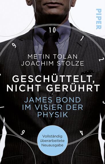 Das Buchcover zeigt einen Mann in einem eleganten Anzug, dessen Kopf im oberen Bereich des Covers sichtbar ist. Er trägt eine Krawatte und hat eine selbstbewusste Haltung. Der Hintergrund ist teilweise in dunklen Grautönen gehalten. In der Mitte des Covers steht der Titel „Geschüttelt, nicht gerührt“ in großen, weißen Buchstaben, während darunter „James Bond im Visier der Physik“ in einer blauen Schriftfarbe platziert ist. Oben sind die Autorennamen Metin Tolan und Joachim Stolze abgedruckt. Unten befindet sich ein blauer runder Button mit dem Text „Vollständig überarbeitete Neuauflage“.