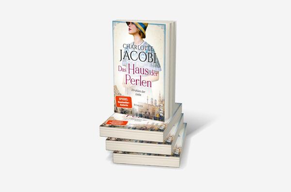 Bücherstapel des Buches „Das Haus der Perlen – Strahlen der Liebe“
