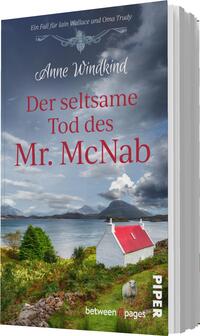 Das Buchcover zeigt eine idyllische Landschaft mit einem roten Haus, umgeben von sanften Hügeln und weidelandtypischer Vegetation. Im Hintergrund erstrecken sich graue, bewölkte Himmel über sanfte Berge. Der Titel „Der seltsame Tod des Mr. McNab“ ist in auffälliger roter Schrift platziert, während der Autorname „Anne Windkind“ in eleganter weißer Schrift darüber steht. Die Atmosphäre vermittelt eine Mischung aus Mystik und ländlicher Idylle.
