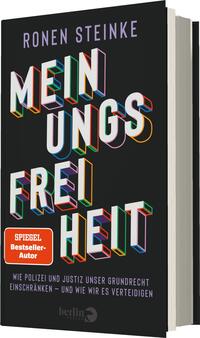 Das Buchcover zeigt einen schwarzen Hintergrund, auf dem der Titel „MEINUNGSFREIHEIT“ prominent in großen, mehrfarbigen Buchstaben dargestellt ist. Der Autor „RONEN STEINKE“ befindet sich oben in weißen Buchstaben. Ein Label in Rot mit dem Text „SPIEGEL-Bestseller-Autor“ ist in der oberen rechten Ecke platziert. Unter dem Titel steht der Untertitel, der in kleinerer Schriftgröße den Inhalt des Buches thematisiert. Die Atmosphäre des Covers wirkt kraftvoll und auffordernd.