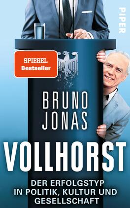 Das Buchcover zeigt einen blauen Hintergrund mit einem stilisierten Podium im Vordergrund. Auf dem Podium steht der Schriftzug „BRUNO JONAS“ in großen, weißen Buchstaben, darunter der Titel „VOLLHORST“ in ebenso markanter Schrift. An der Seite des Podiums ist ein lächelnder Mann, der die Hand hebt. Oben links befindet sich ein rotes Qualitätssiegel mit dem Text „SPIEGEL Bestseller“. Der Gesamteindruck vermittelt eine humorvolle, satirische Atmosphäre.