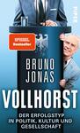 Das Buchcover zeigt einen blauen Hintergrund mit einem stilisierten Podium im Vordergrund. Auf dem Podium steht der Schriftzug „BRUNO JONAS“ in großen, weißen Buchstaben, darunter der Titel „VOLLHORST“ in ebenso markanter Schrift. An der Seite des Podiums ist ein lächelnder Mann, der die Hand hebt. Oben links befindet sich ein rotes Qualitätssiegel mit dem Text „SPIEGEL Bestseller“. Der Gesamteindruck vermittelt eine humorvolle, satirische Atmosphäre.