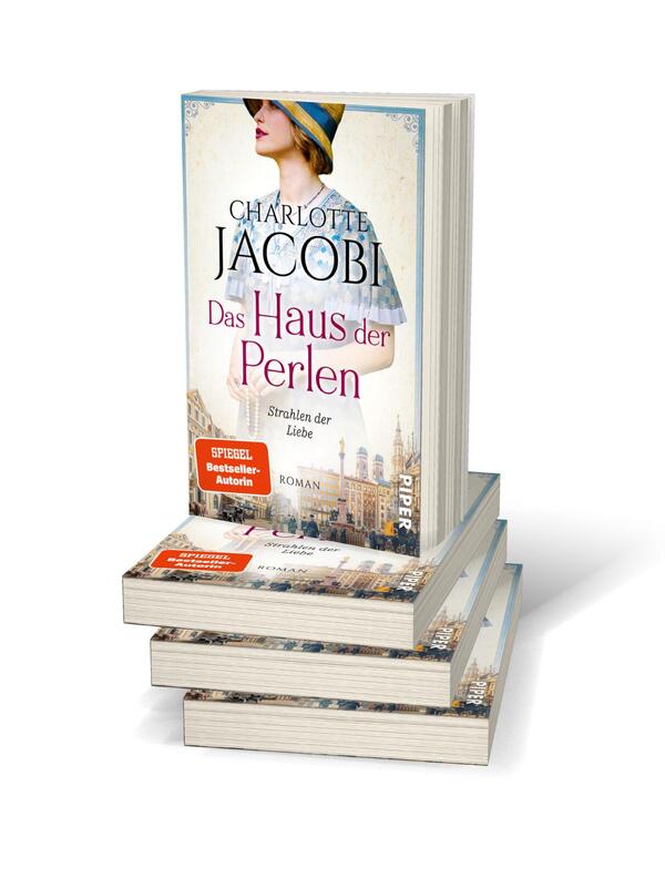 Bücherstapel des Buches „Das Haus der Perlen – Strahlen der Liebe“