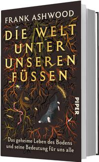Das Buchcover zeigt ein dunkles, erdiges Motiv mit dicht verzweigten Wurzeln in Orange-, Gelb- und Rottönen vor schwarzem bis braunem Hintergrund. Großformatiger Titel „DIE WELT UNTER UNSEREN FÜSSEN“ in gelbgoldener, serifenbetonter Majuskeltypografie, darüber der Autorenname „FRANK ASHWOOD“. Im Vordergrund ein schwarzer Maulwurf, umgeben von Regenwurm, Hundertfüßer und weiteren Bodeninsekten. Stimmung: geheimnisvoll und naturwissenschaftlich; unten die weiße Unterzeile „Das geheime Leben des Bodens und seine Bedeutung für uns alle“.