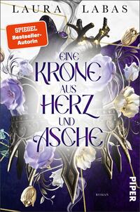 Das Buchcover zeigt eine stilisierte Krone, die aus imposanten, dunklen Materialien gefertigt zu sein scheint, umgeben von zarten lila Blumen. Der Titel „EINE KRONE AUS HERZ UND ASCHE“ ist in großen, eleganten Lettern zentral platziert, wobei das Wort „HERZ“ hervorgehoben ist. Oben auf dem Cover steht der Name der Autorin, Laura Labas, und ein rotes Kästchen mit der Aufschrift „SPIEGEL-Bestseller-Autorin“. Der gesamte Hintergrund ist in tiefen, mystischen Farbtönen gehalten, die eine düstere, aber auch fesselnde Atmosphäre erzeugen.