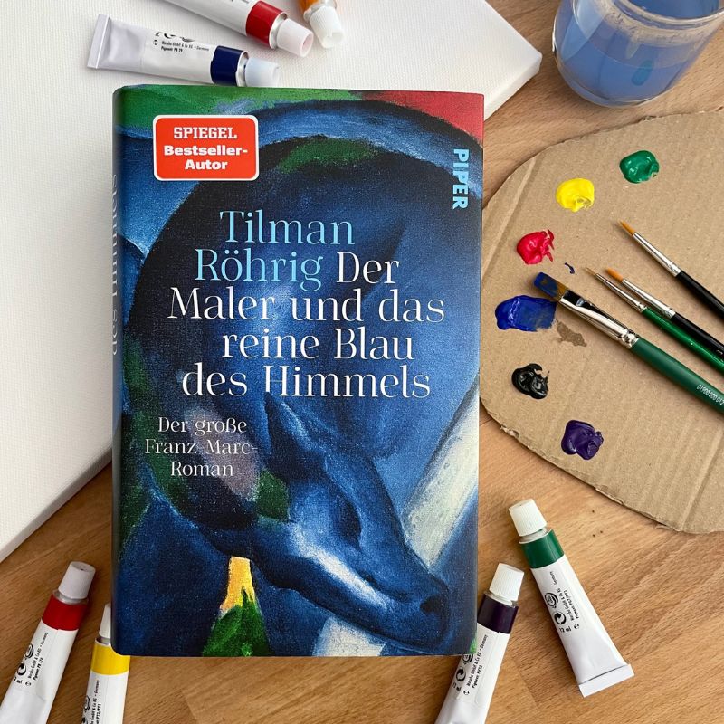 Roman über Franz Marc von Tilman Röhrig umgeben von Maler-Utensilien